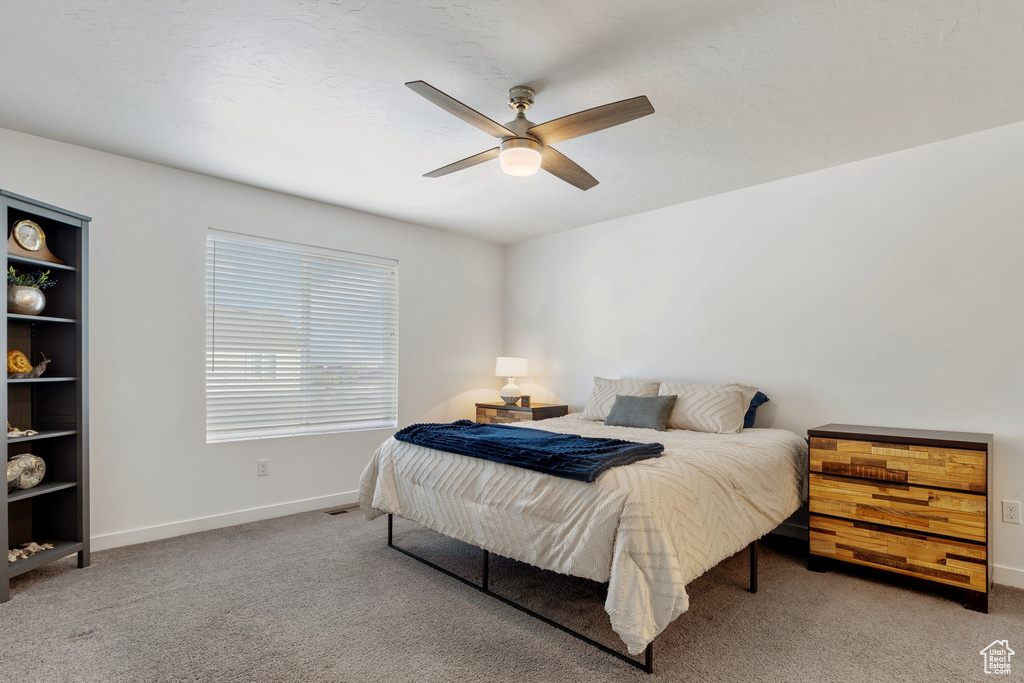 Bedroom featuring carpet flooring, baseboards, and a ceiling fan
