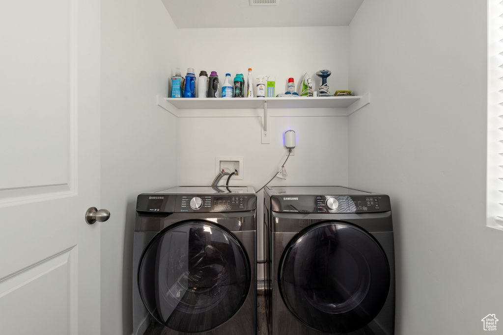Washroom featuring washing machine and dryer