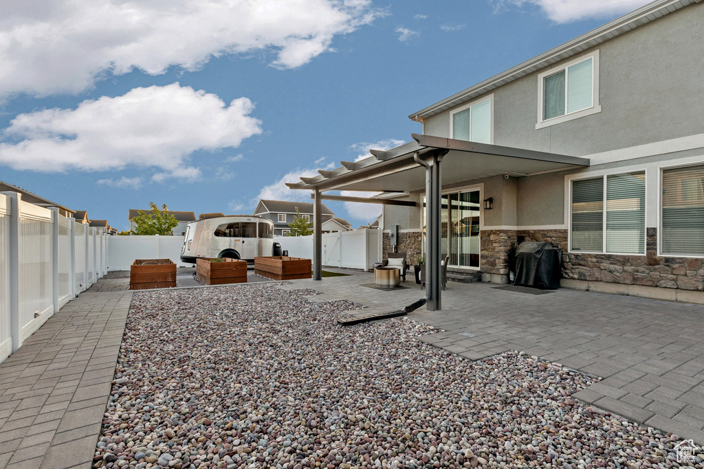 Fenced backyard with a patio area and outdoor lounge area