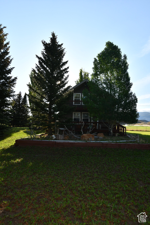Rear view of house featuring a lawn