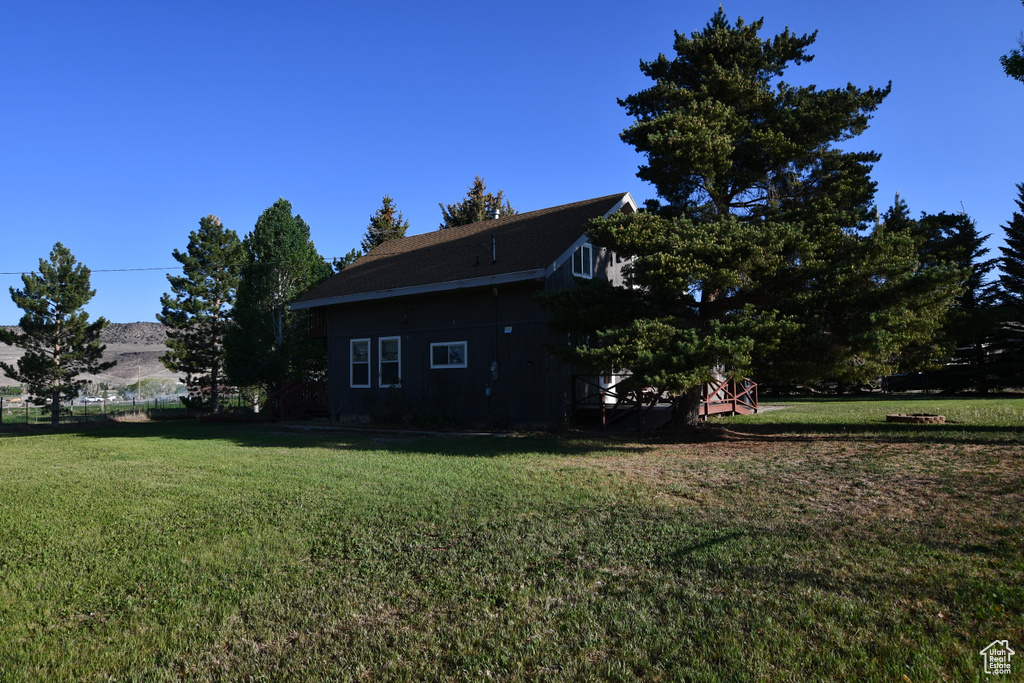 View of property exterior featuring a lawn
