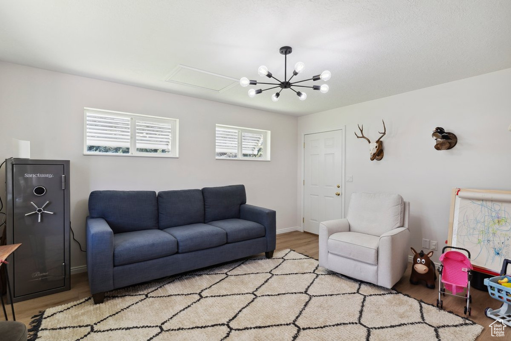 Living area with light wood-style flooring and a chandelier