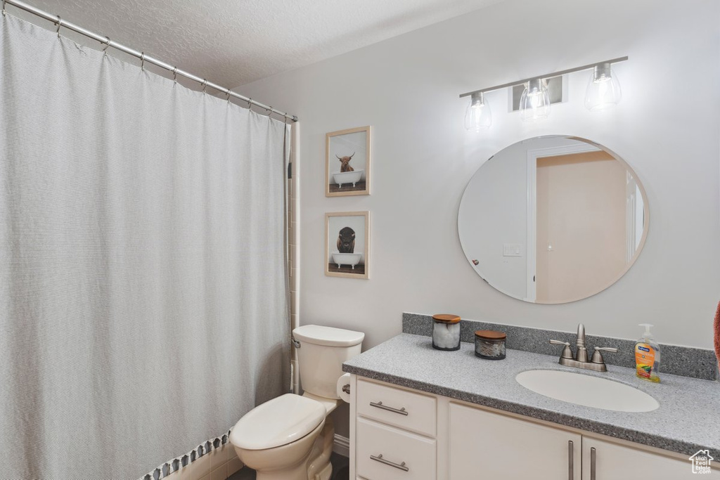 Bathroom featuring vanity and a textured ceiling