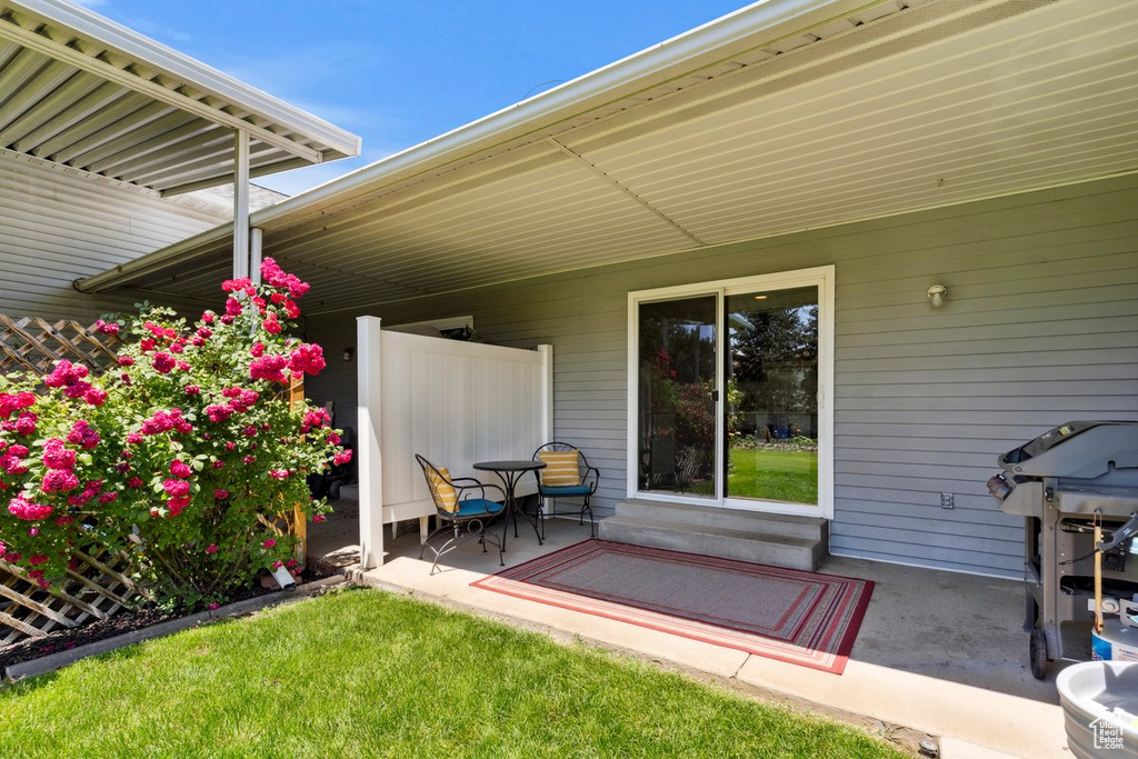 View of patio with a grill