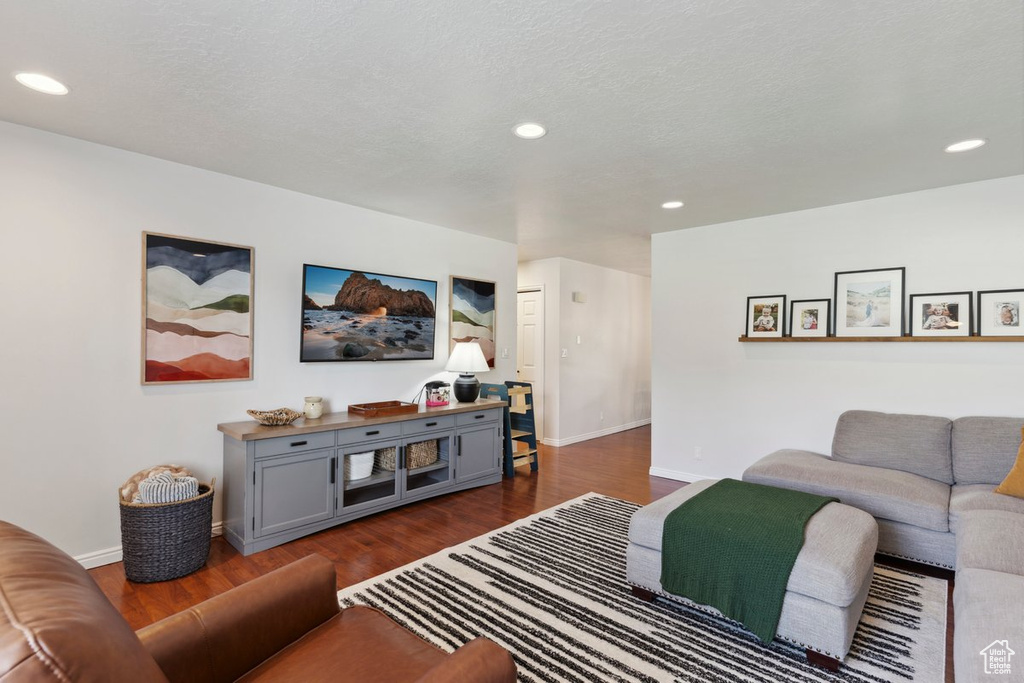 Living room featuring dark wood-style floors and recessed lighting
