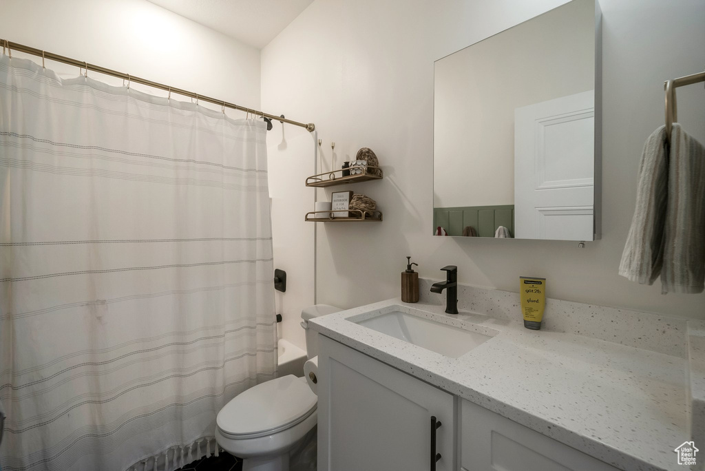 Full bathroom featuring vanity and shower / tub combo with curtain