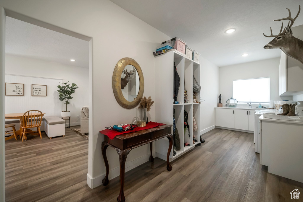 Corridor featuring wood finished floors and recessed lighting