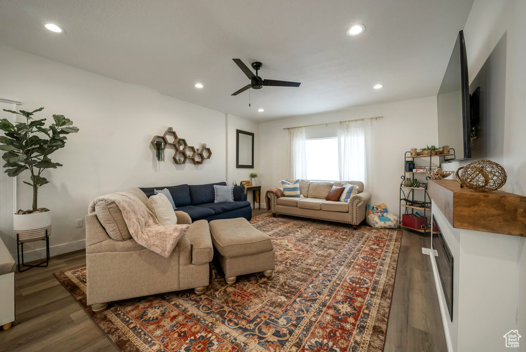 Living area featuring wood finished floors, a ceiling fan, and recessed lighting