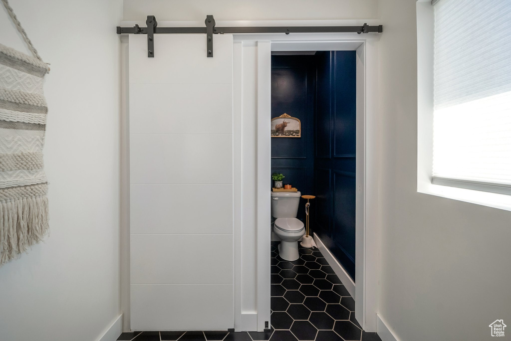 Bathroom featuring toilet and tile patterned flooring