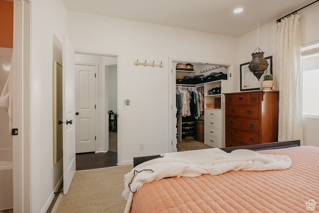 Bedroom with carpet, a walk in closet, a closet, and recessed lighting