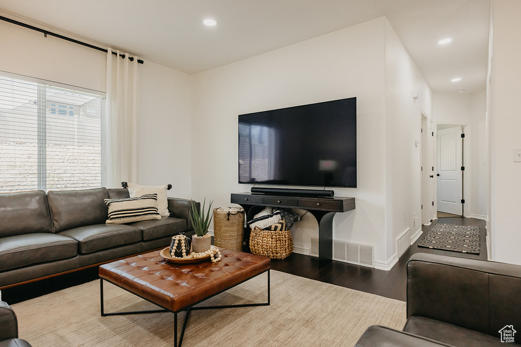 Living area featuring wood finished floors and recessed lighting