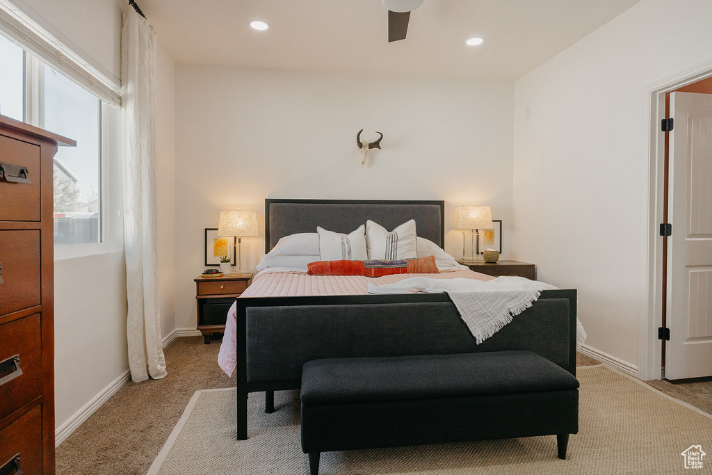 Bedroom with light colored carpet, a ceiling fan, and recessed lighting