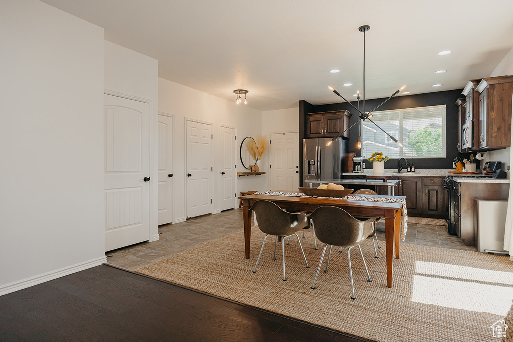 Kitchen with stainless steel appliances, light countertops, dark brown cabinetry, recessed lighting, and pendant lighting