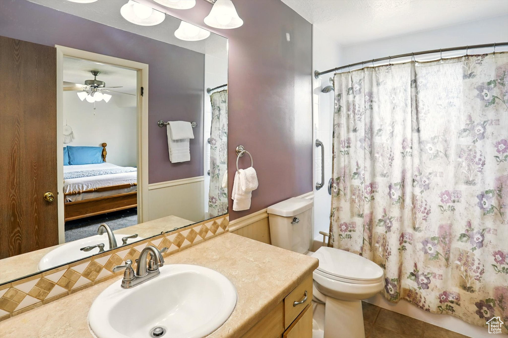 Bathroom featuring connected bathroom, vanity, tile patterned floors, ceiling fan, and a shower with curtain