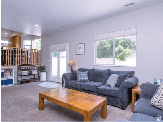 Living area with carpet flooring and recessed lighting