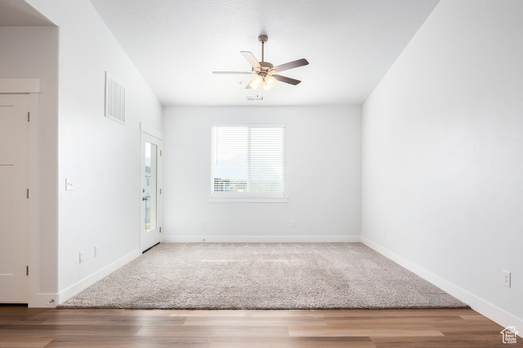 Spare room featuring a ceiling fan and wood finished floors