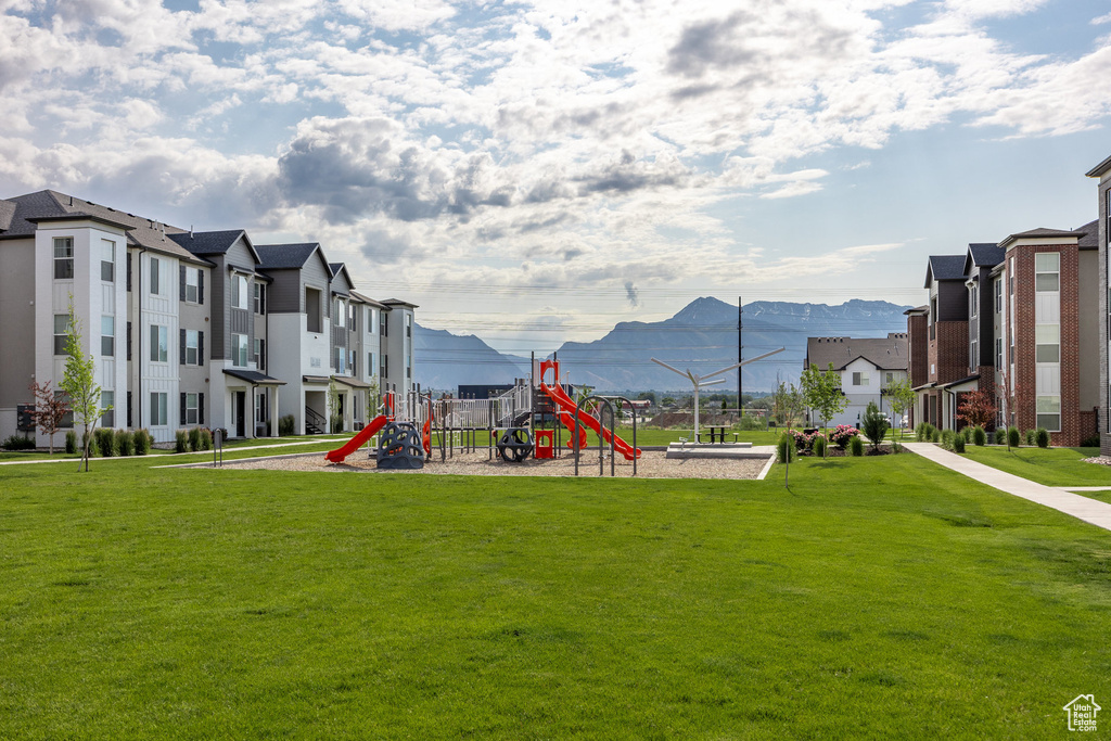 Community play area featuring a lawn and a residential view
