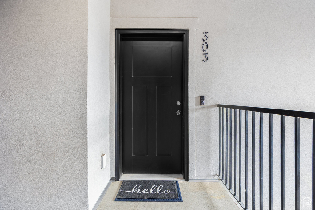 Doorway to property featuring stucco siding