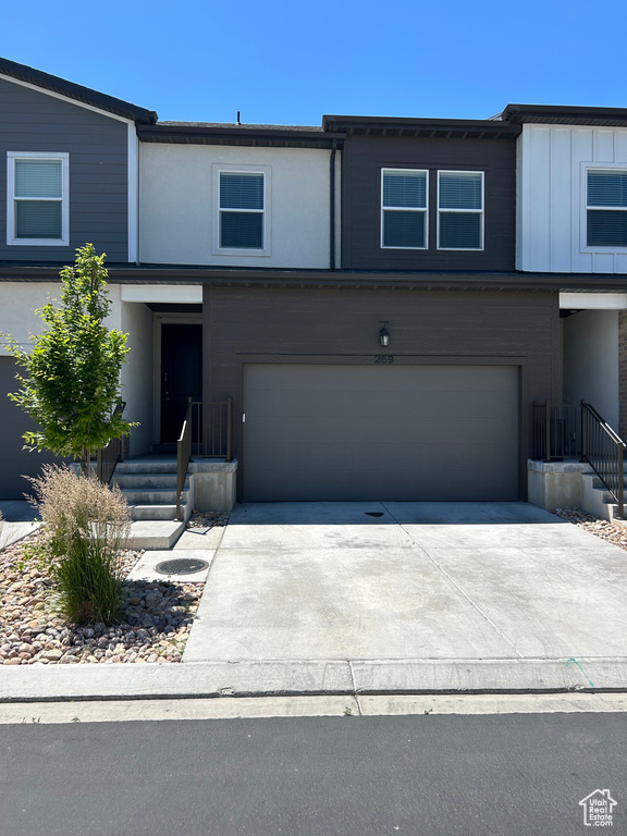 View of front of home with a garage and driveway