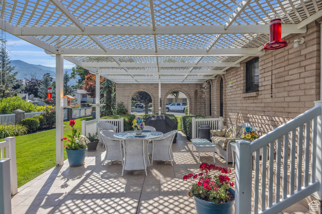 View of patio featuring outdoor dining area, a pergola, and a mountain view