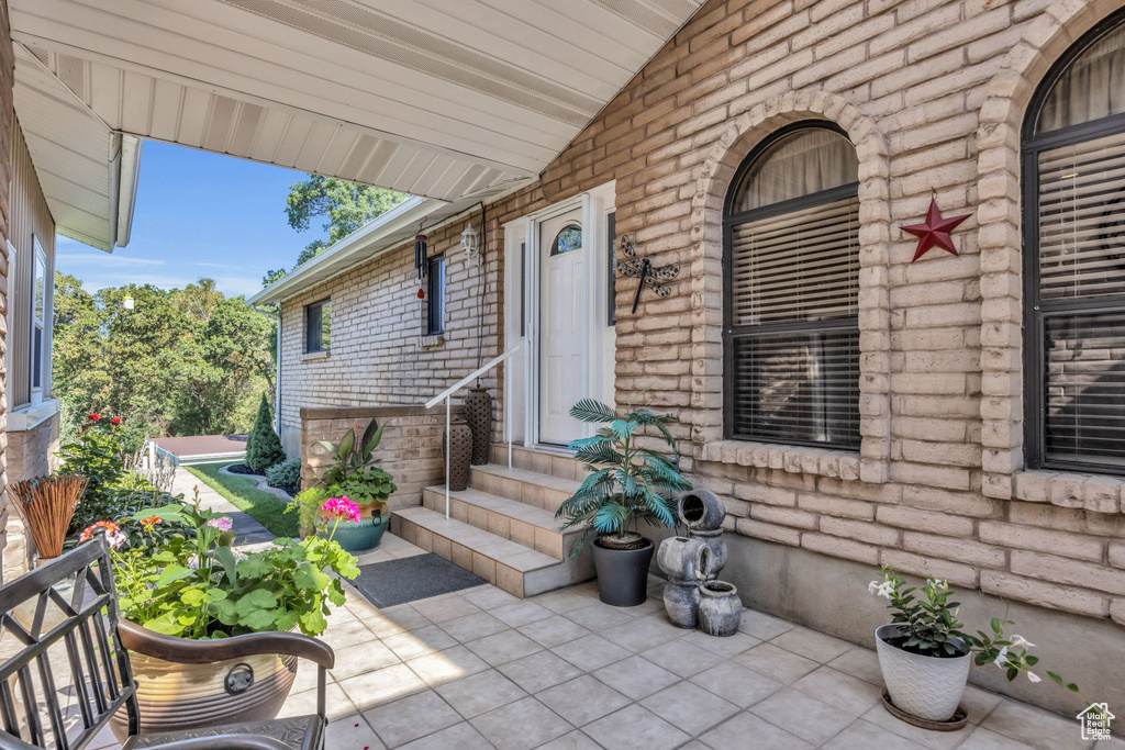 Property entrance featuring brick siding