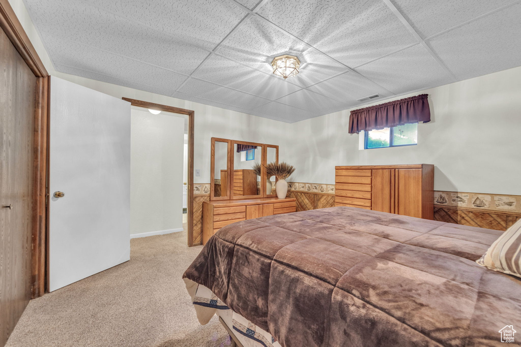 Bedroom with carpet flooring and wainscoting