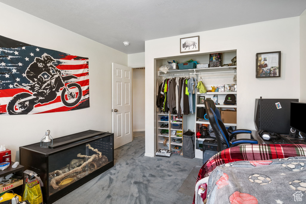 Bedroom featuring carpet flooring, a closet, and an office area