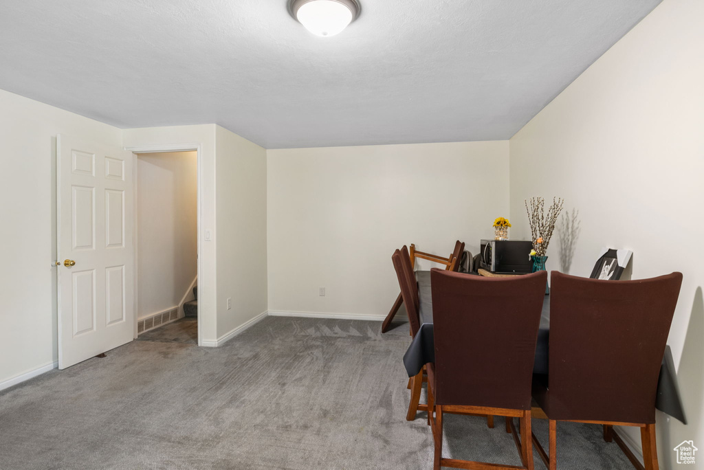 Dining space with carpet floors and an office area