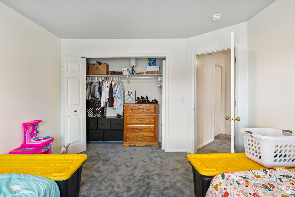 Carpeted bedroom featuring a closet
