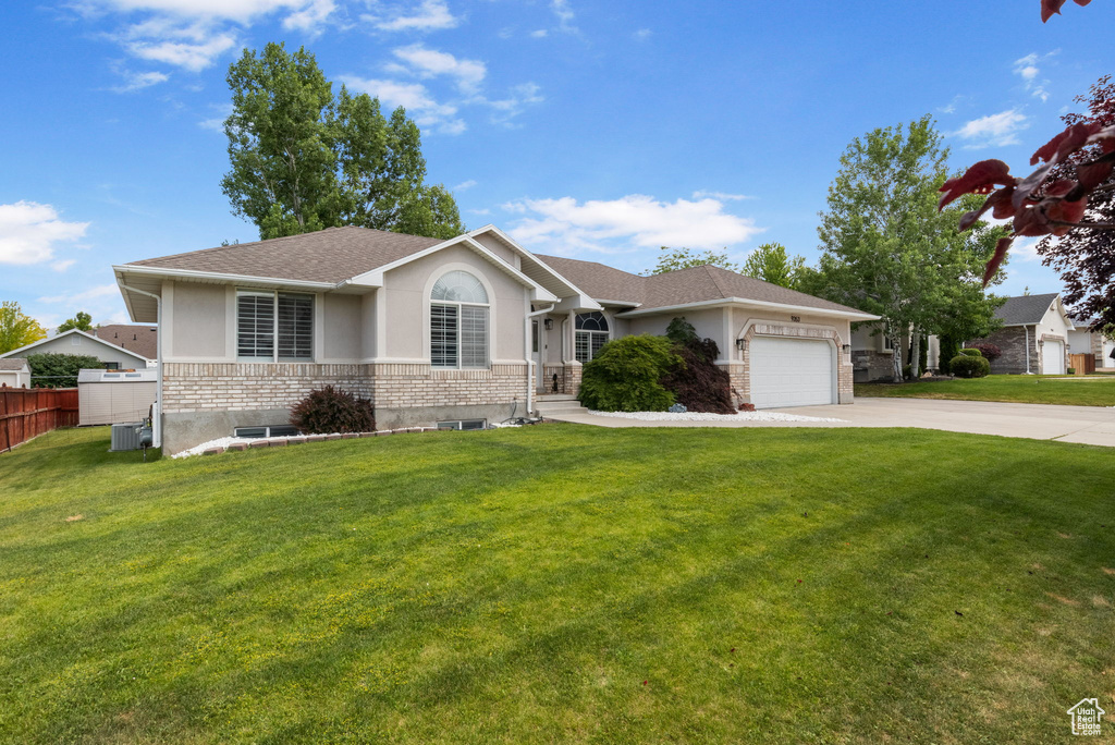 Ranch-style house with stucco siding, concrete driveway, an attached garage, and roof with shingles