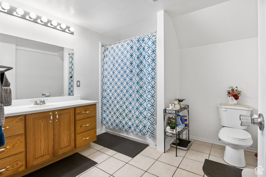 Full bath with vanity, tile patterned flooring, and shower / bath combination with curtain