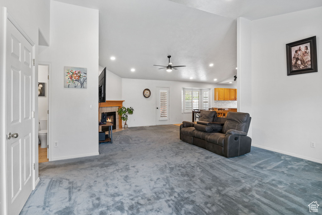 Carpeted living area featuring recessed lighting, ceiling fan, and a tile fireplace
