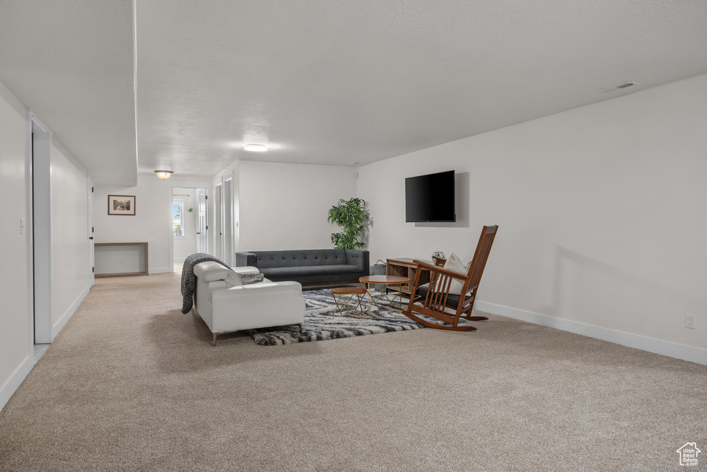 Living room featuring light colored carpet and baseboards