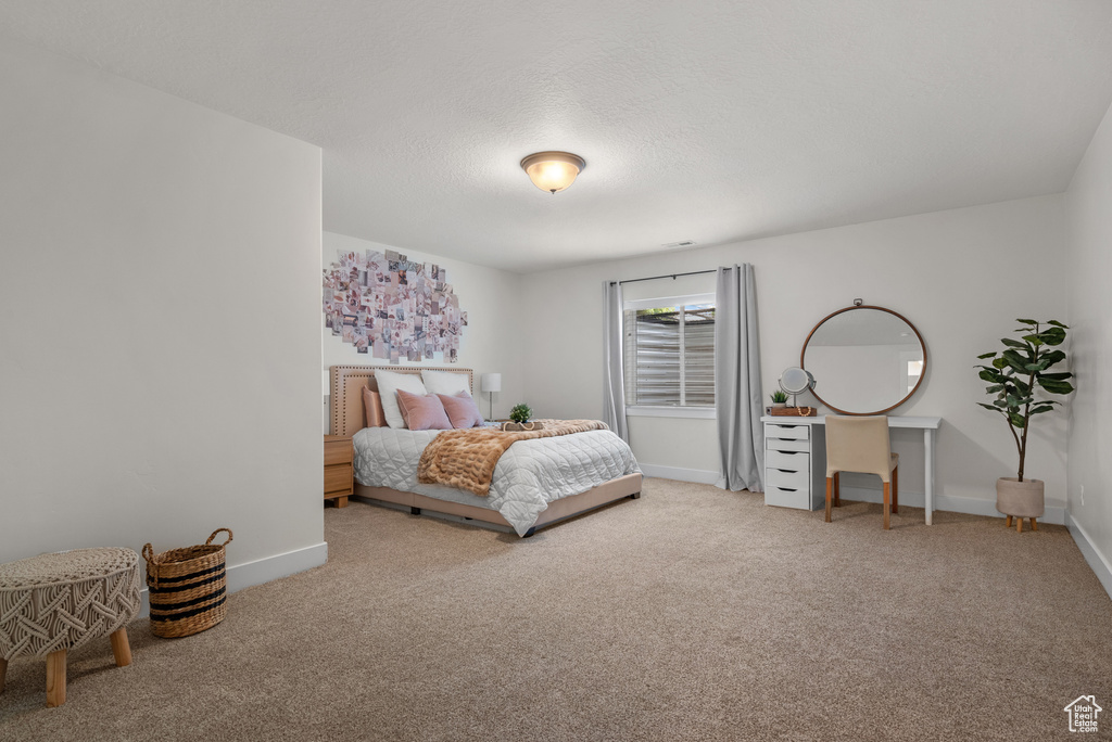 Carpeted bedroom with baseboards