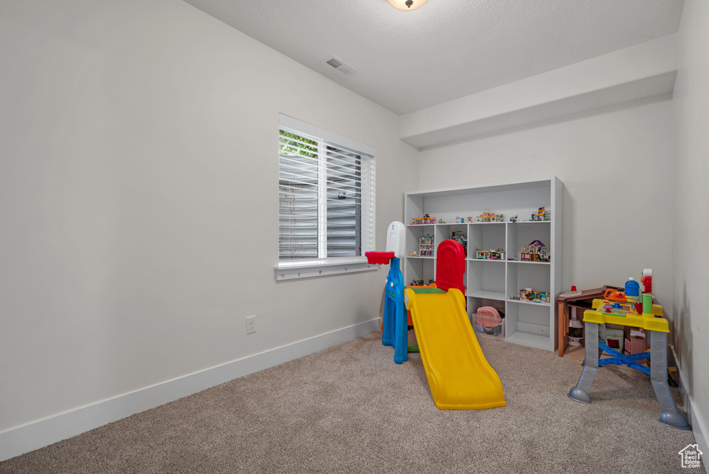 Rec room featuring carpet and baseboards