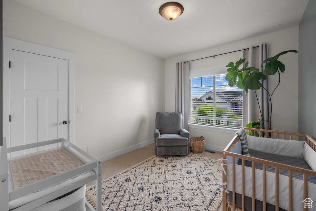 Carpeted bedroom with baseboards