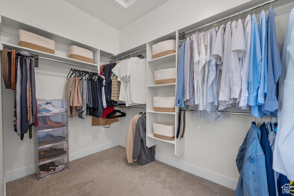 Walk in closet with carpet flooring