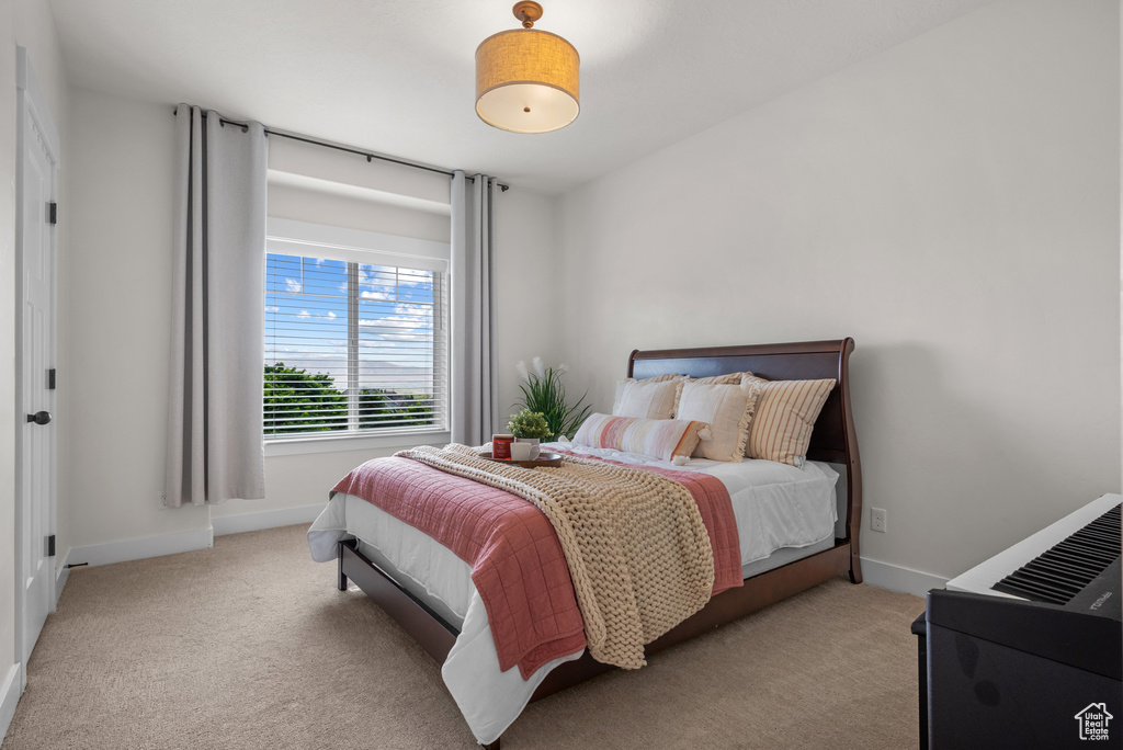 Carpeted bedroom with baseboards