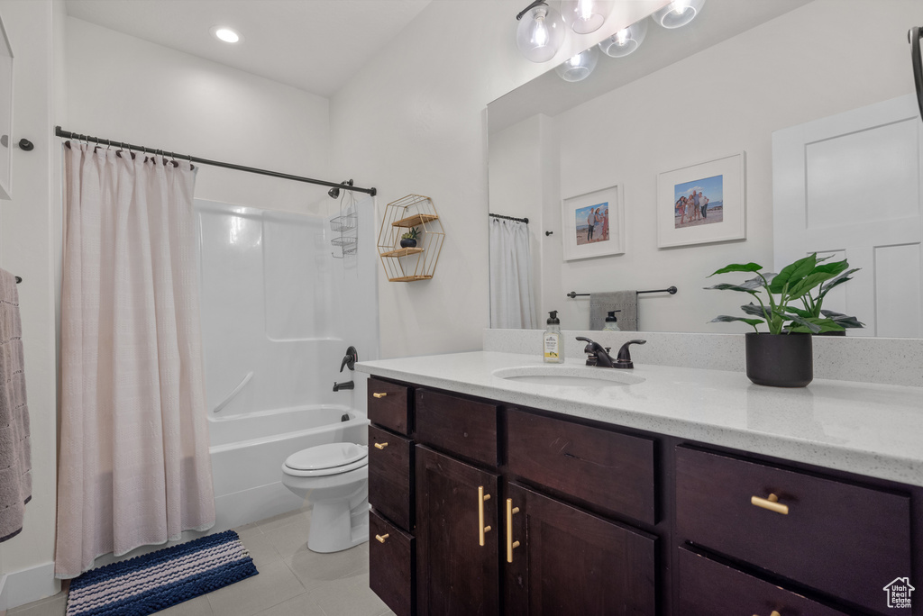 Full bath featuring vanity, shower / tub combo with curtain, and tile patterned floors