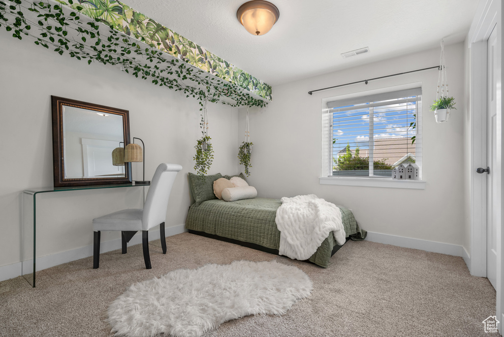 Carpeted bedroom featuring baseboards