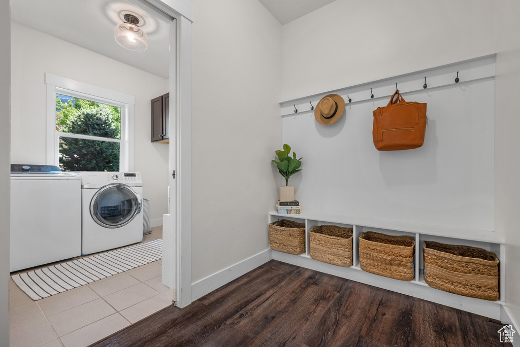 Laundry room featuring washing machine and clothes dryer and dark wood-type flooring