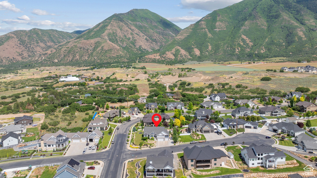 Aerial view of property\'s location featuring a mountainous background and nearby suburban area