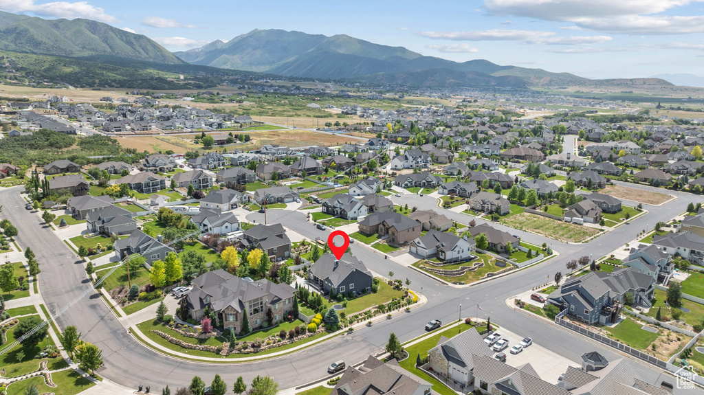 Aerial overview of property\'s location with a mountain backdrop and nearby suburban area