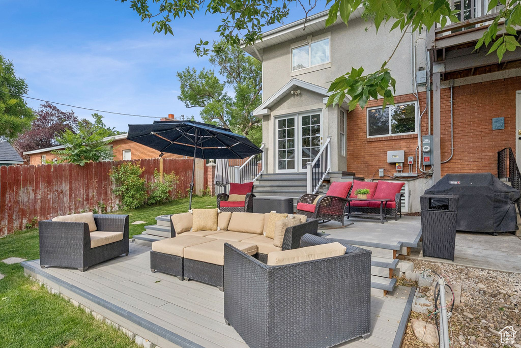 Wooden terrace featuring an outdoor living space, entry steps, and a grill