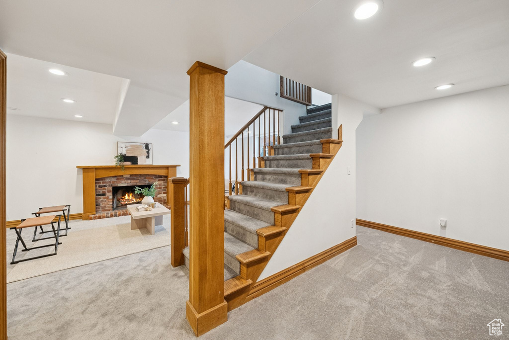 Stairs with carpet flooring, recessed lighting, and a fireplace