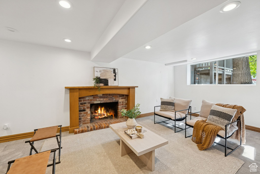 Carpeted living area featuring recessed lighting and a fireplace