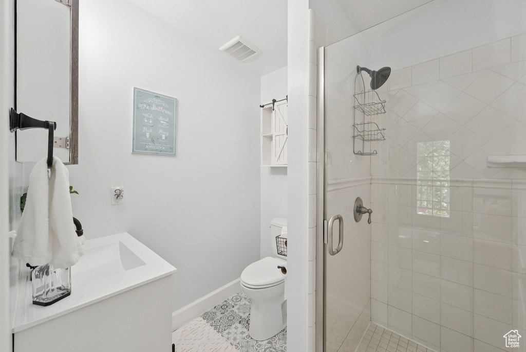 Bathroom with vanity, a shower stall, and tile patterned floors