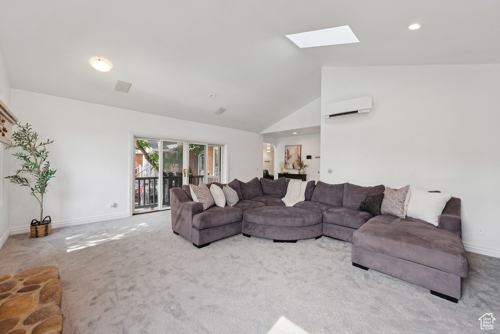 Living room featuring a wall mounted AC, a skylight, carpet, lofted ceiling, and recessed lighting