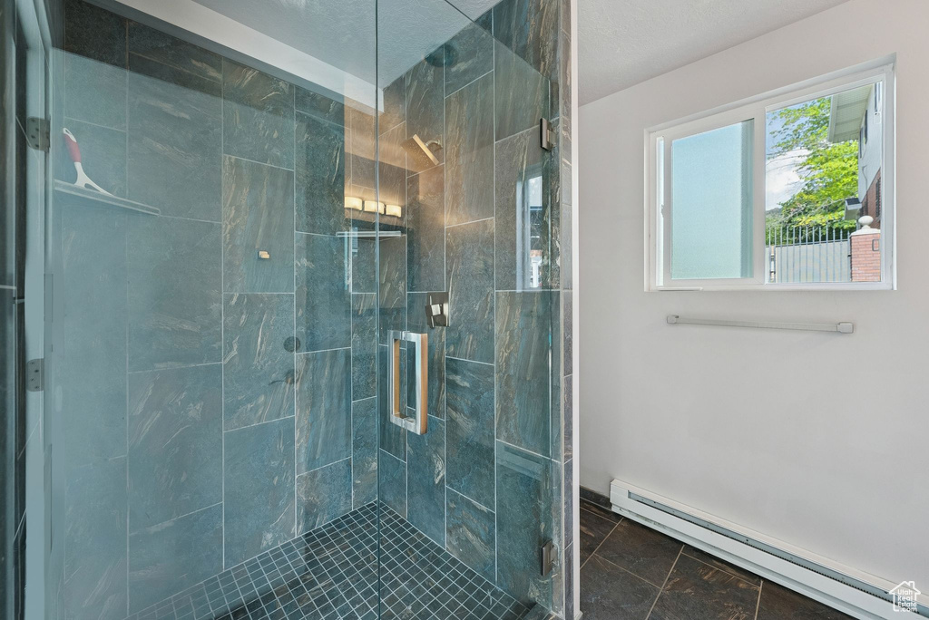 Bathroom featuring a baseboard radiator and a stall shower