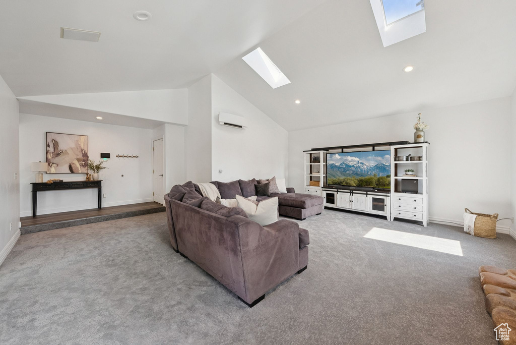 Living room featuring a skylight, carpet floors, an AC wall unit, high vaulted ceiling, and recessed lighting